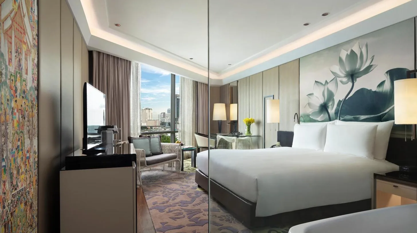 a bathroom with two sinks and a large mirror at Siam Kempinski Hotel Bangkok in Bangkok