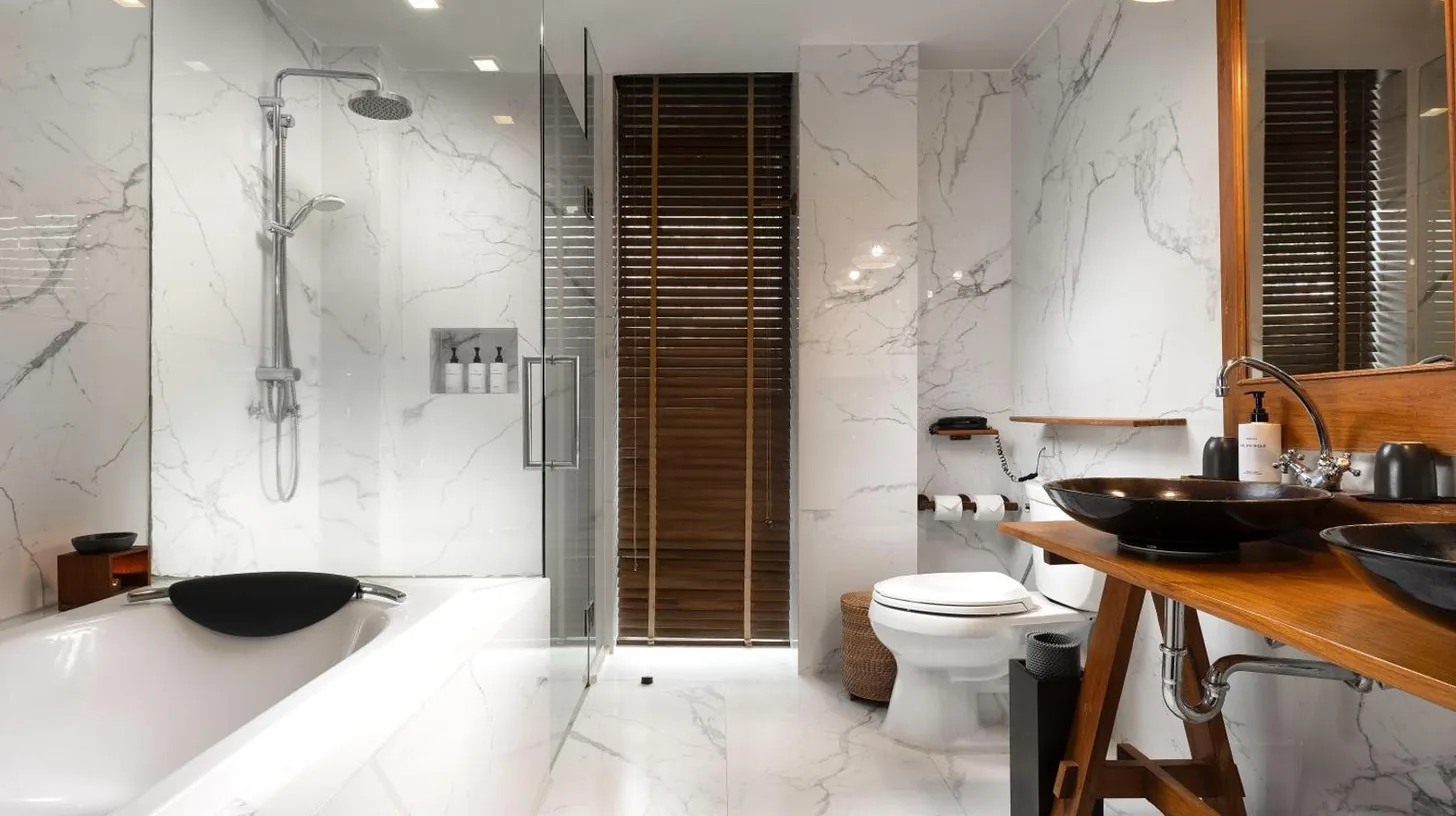 a bathroom with a tub and a toilet and a sink at Silavadee Pool Spa Resort - SHA Extra Plus in Lamai