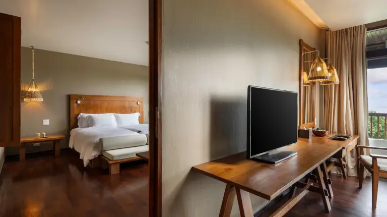 a bedroom with a bed and a flat screen tv at Silavadee Pool Spa Resort - SHA Extra Plus in Lamai