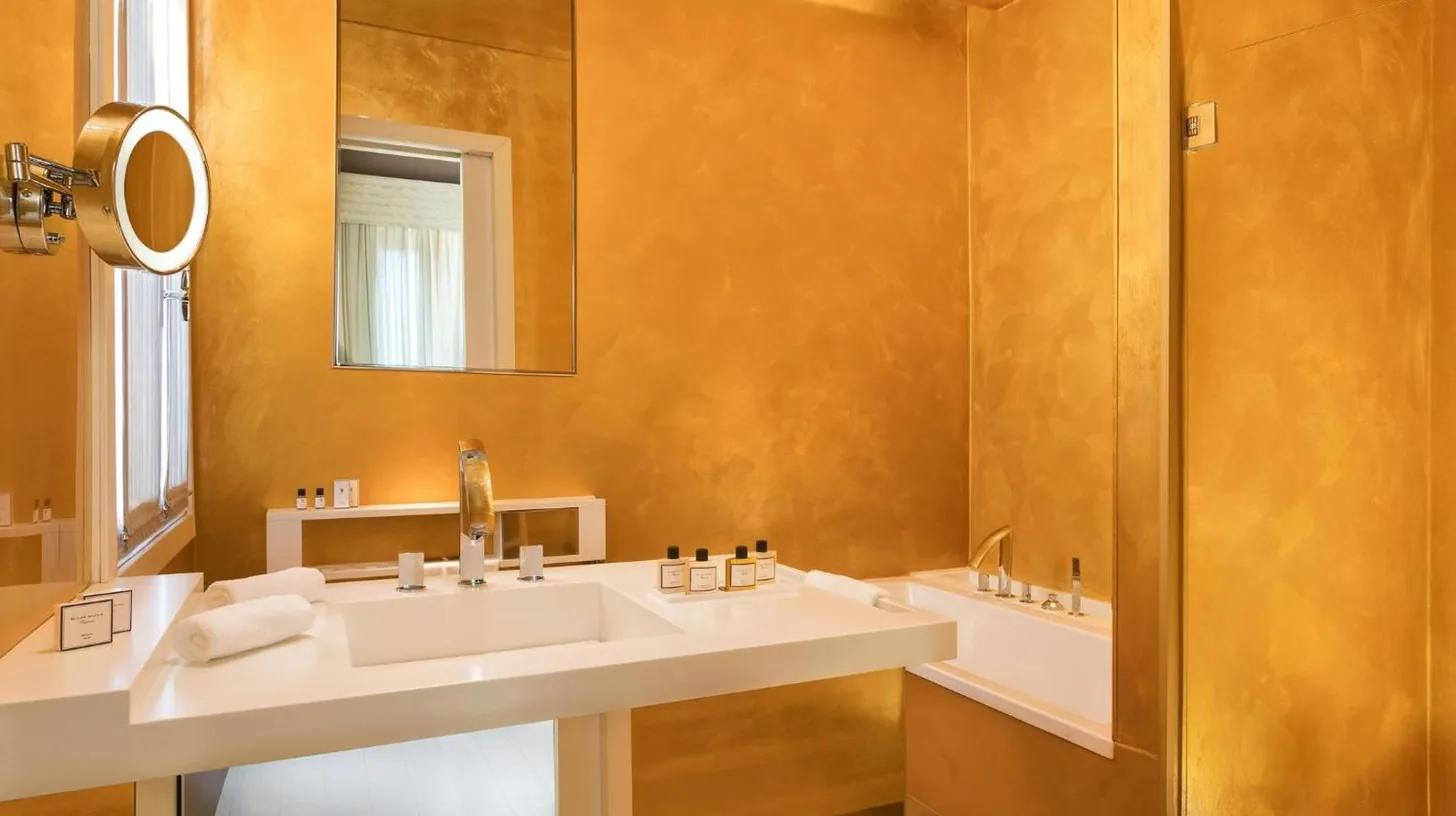 a bathroom with two sinks and a mirror at Sina Centurion Palace in Venice
