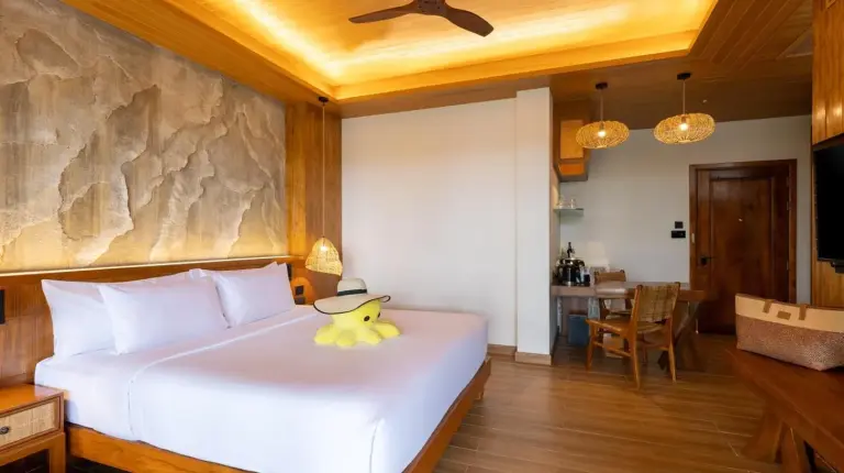 a bedroom with a bed with a duck toy on it at SINAE Phuket Luxury Hotel in Phuket Town