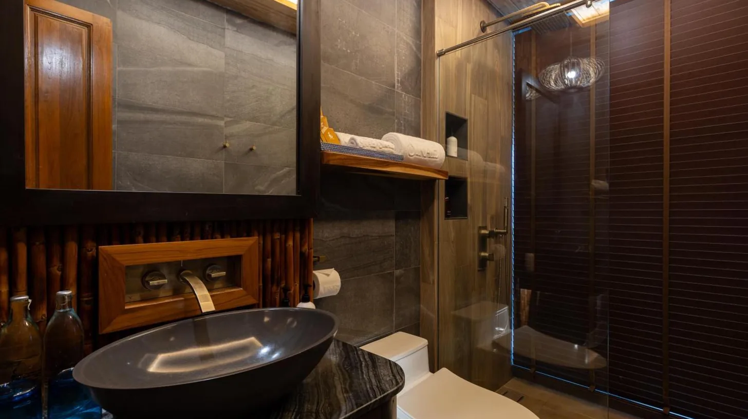 a bathroom with a sink and a toilet at SINAE Phuket Luxury Hotel in Phuket Town