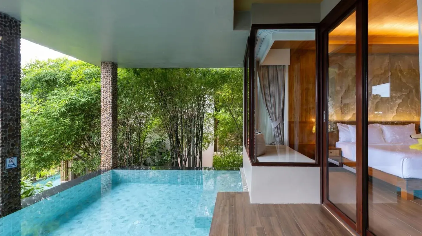 a room with a pool and a bed and a bedroom at SINAE Phuket Luxury Hotel in Phuket Town