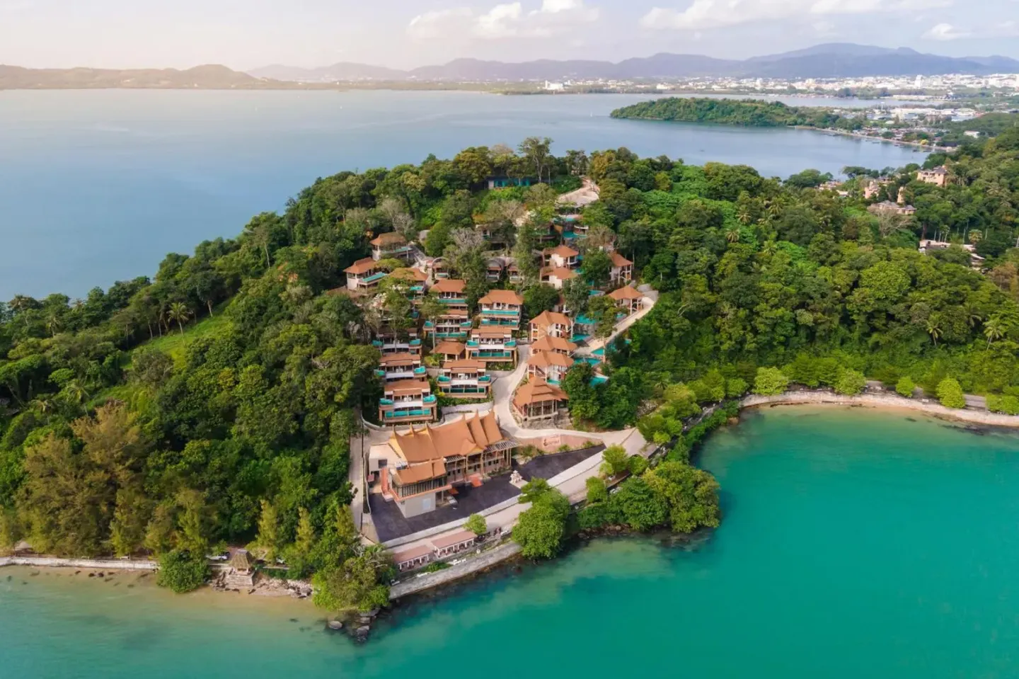 Aerial view of SINAE Phuket Luxury Hotel, showcasing its lush surroundings and proximity to water.