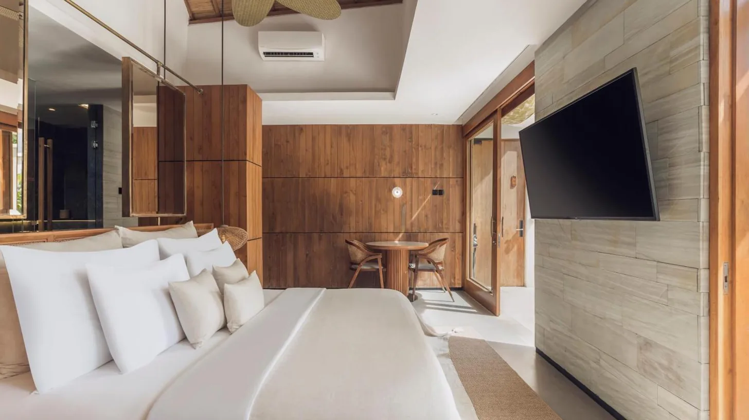a bedroom with a bed and a swimming pool at Sini Vie Resort & Spa Seminyak by Ini Vie Hospitality in Seminyak