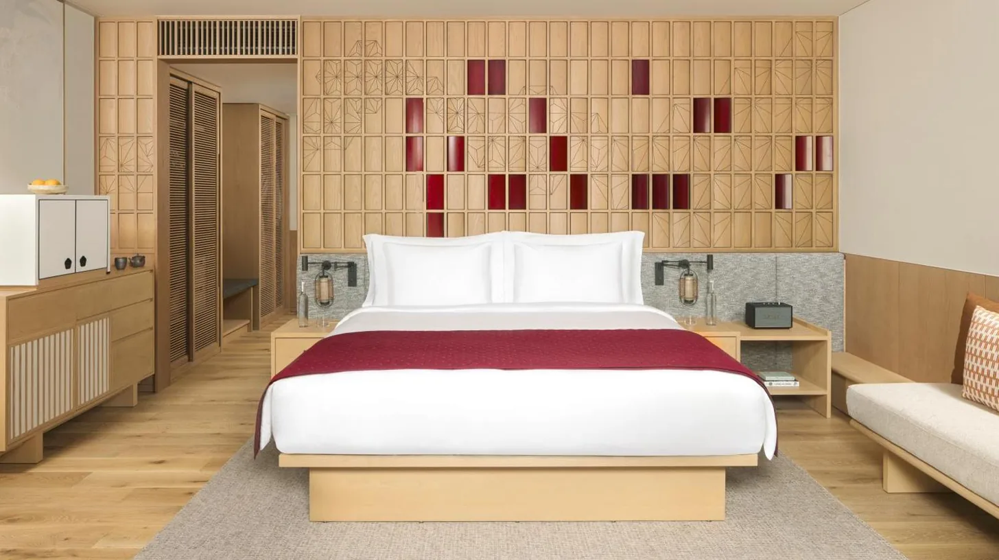 a bedroom with a large bed and a couch at Six Senses Kyoto in Kyoto