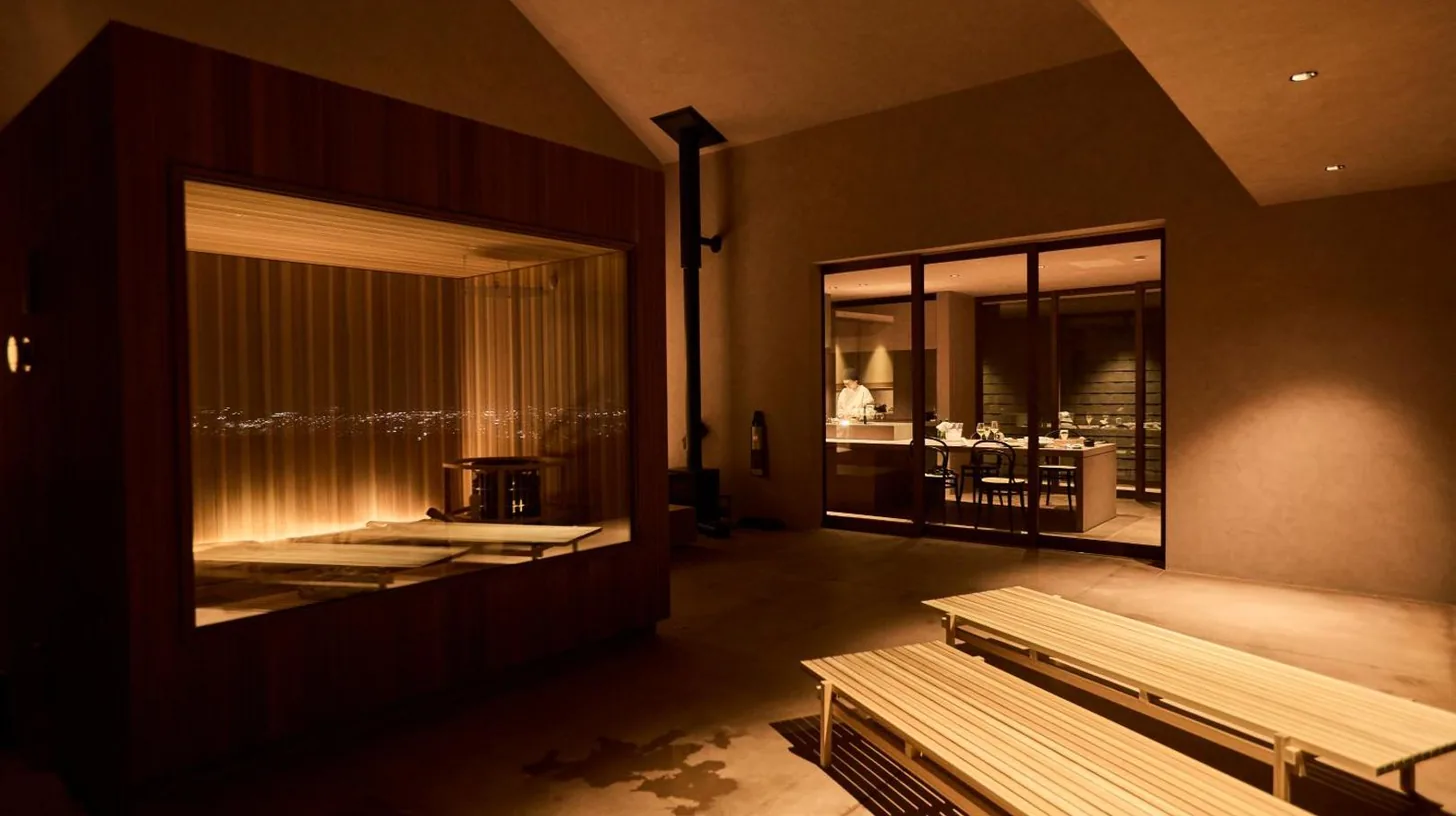 a room with two benches and a large window at Snow Peak YAKEI SUITE ABURAYAMA FUKUOKA in Fukuoka