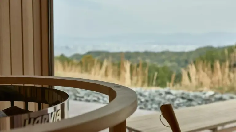 a table and chairs in front of a window at Snow Peak YAKEI SUITE ABURAYAMA FUKUOKA in Fukuoka