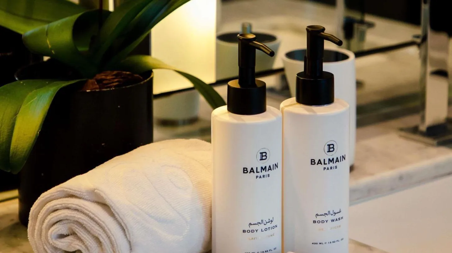 a couple of bottles of soap sitting next to a towel at Sofitel Dubai Downtown in Dubai