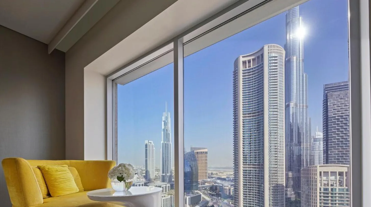a hotel room with two beds and a window at Sofitel Dubai Downtown in Dubai