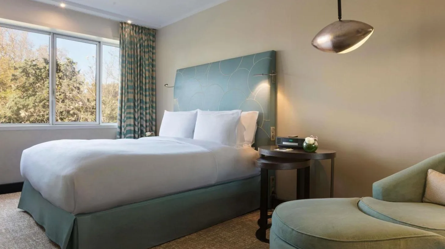 a hotel room with a large bed and a chair at Sofitel Marseille Vieux-Port in Marseille