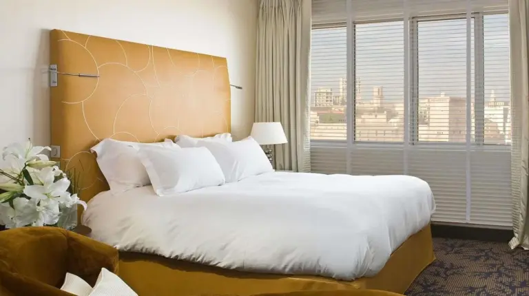 a bedroom with a large bed and a large window at Sofitel Marseille Vieux-Port in Marseille