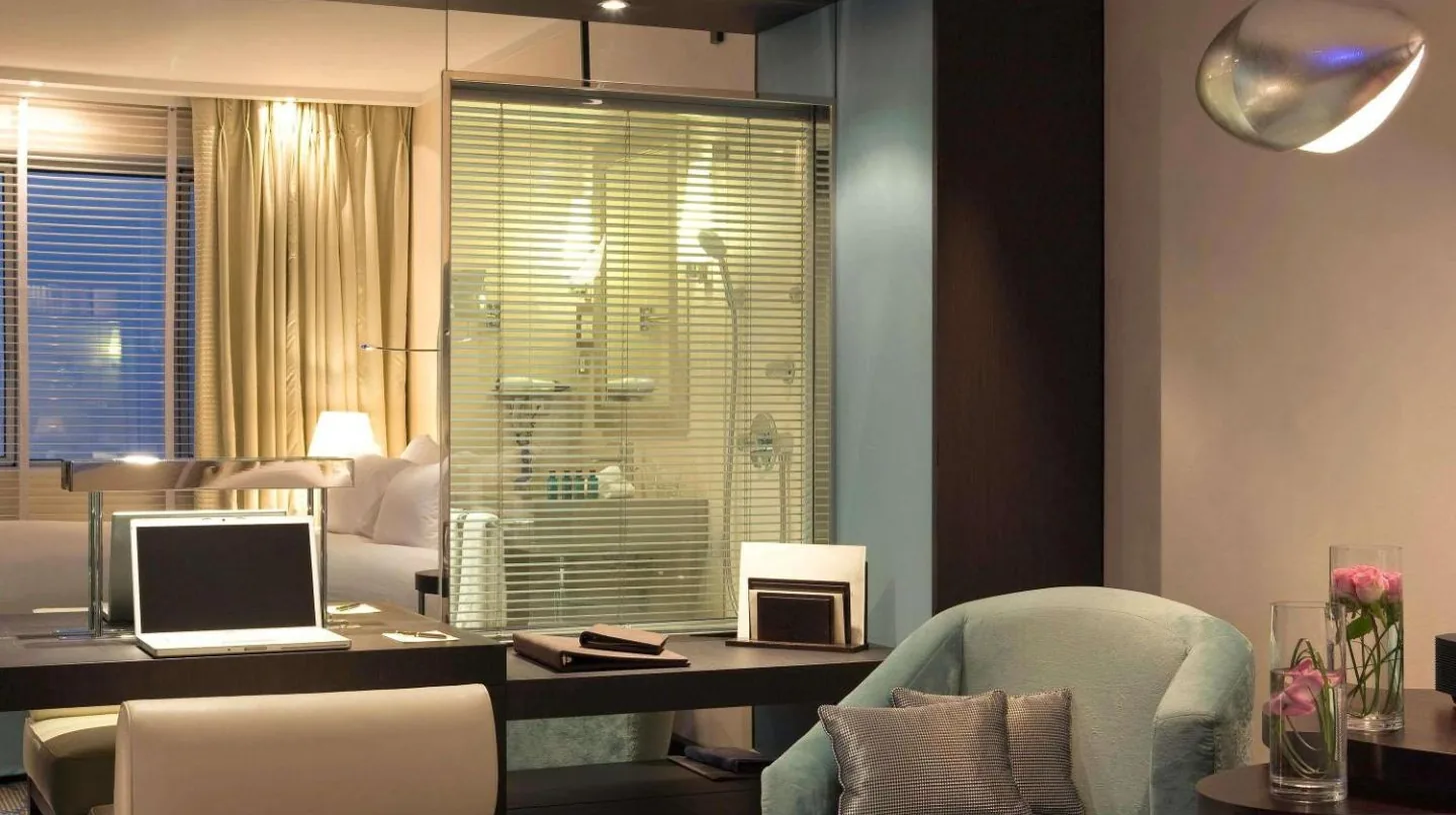a room with a desk with a laptop and a chair at Sofitel Marseille Vieux-Port in Marseille