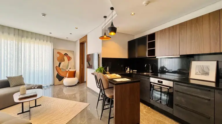 a kitchen and living room with a couch and a table at Soho Boutique Casablanca in Casablanca