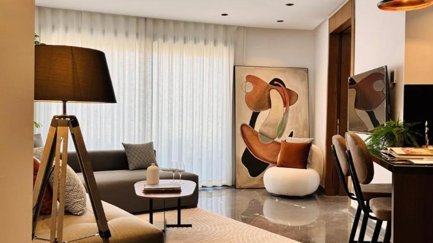 a living room with couches and a table and chairs at Soho Boutique Casablanca in Casablanca