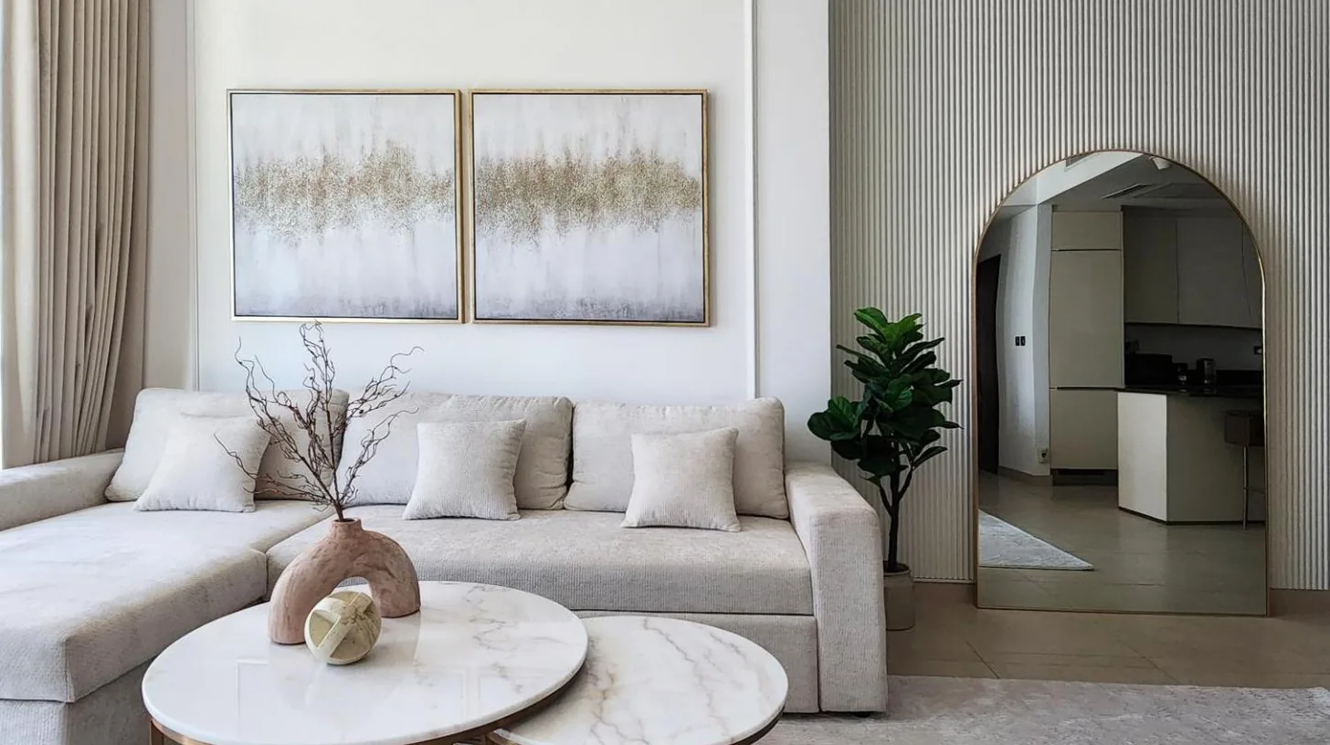 a living room with a couch and a table at SOLARTE Luxe - Marina Gate - Spectacular Pools with Marina Views in Dubai