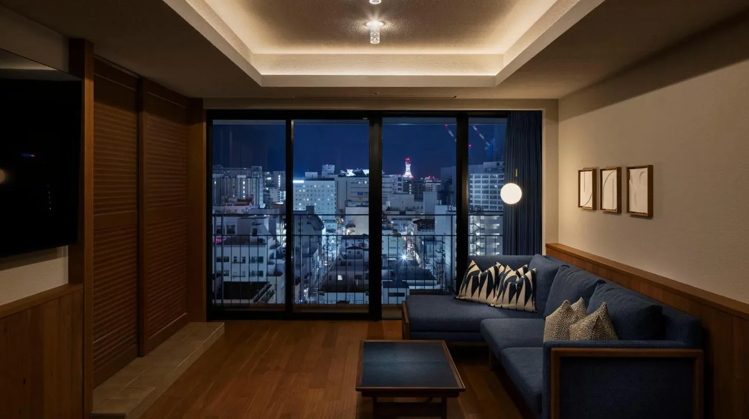 a living room with a couch and a large window at Southwest Grand Hotel in Naha