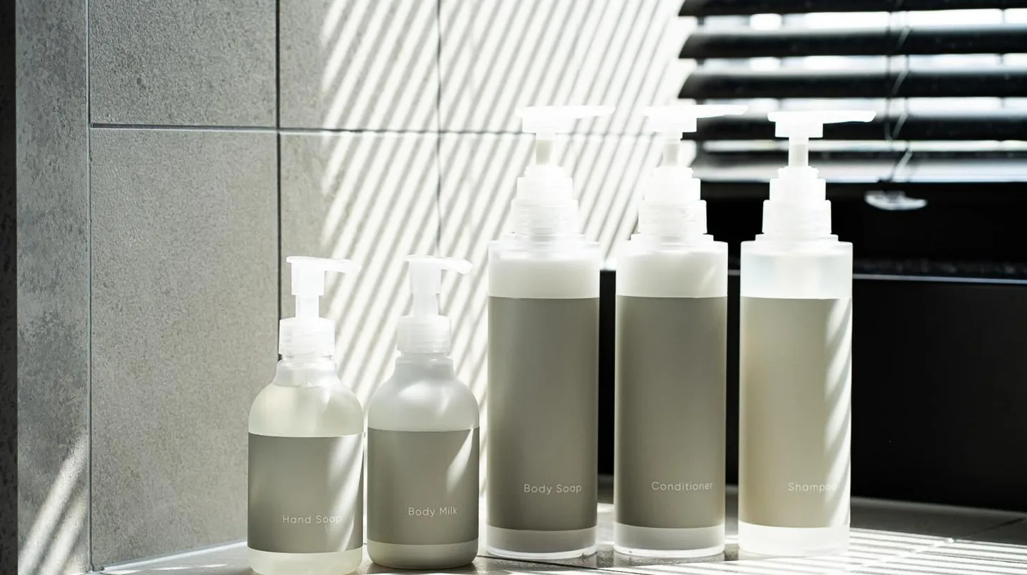a group of four bottles sitting on a shelf at Southwest Grand Hotel in Naha