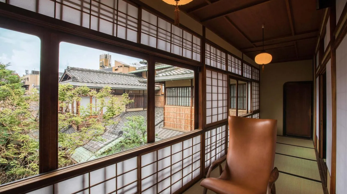 an empty room with a chair and a window at Sowaka in Kyoto