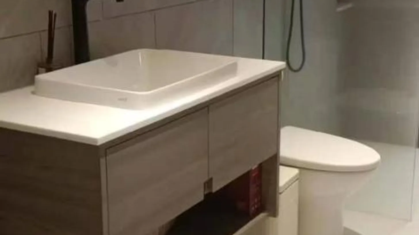 a bathroom with a white sink and a mirror at The Akbar Villa in Bang Rak Beach