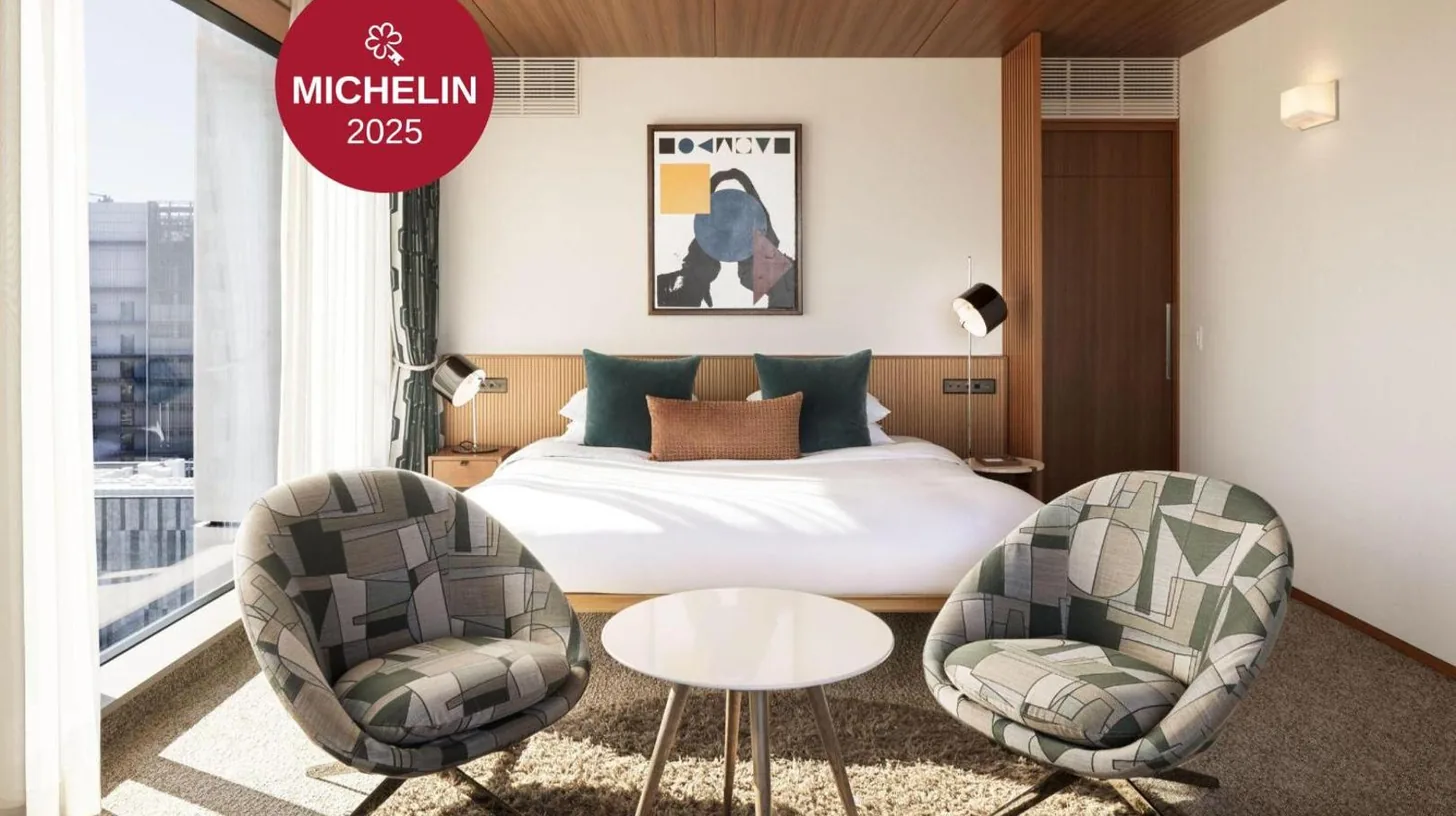 a hotel room with a bed and two chairs at THE AOYAMA GRAND HOTEL in Tokyo