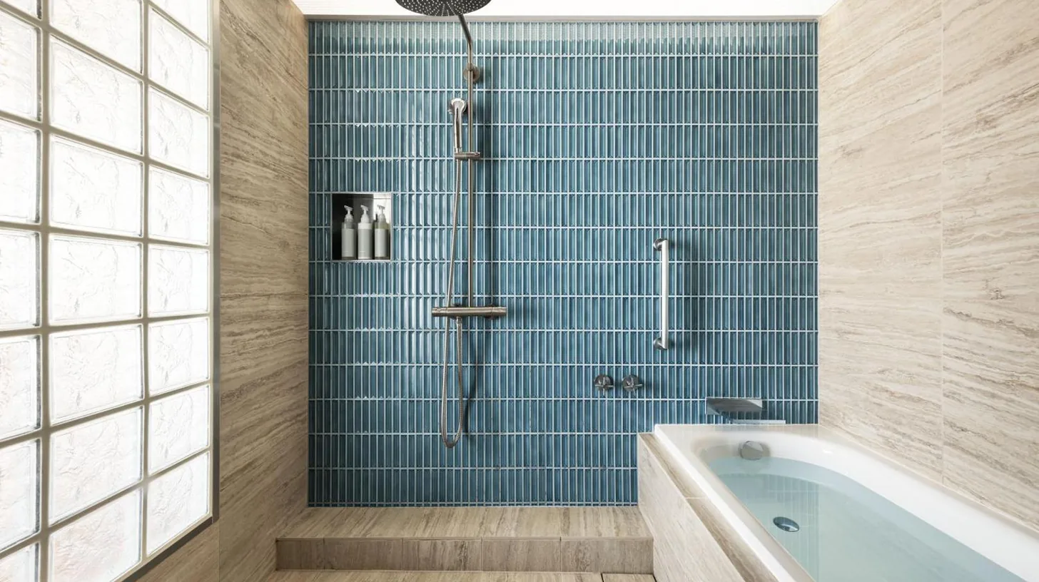 a bathroom with a tub and a shower with blue tiles at THE AOYAMA GRAND HOTEL in Tokyo
