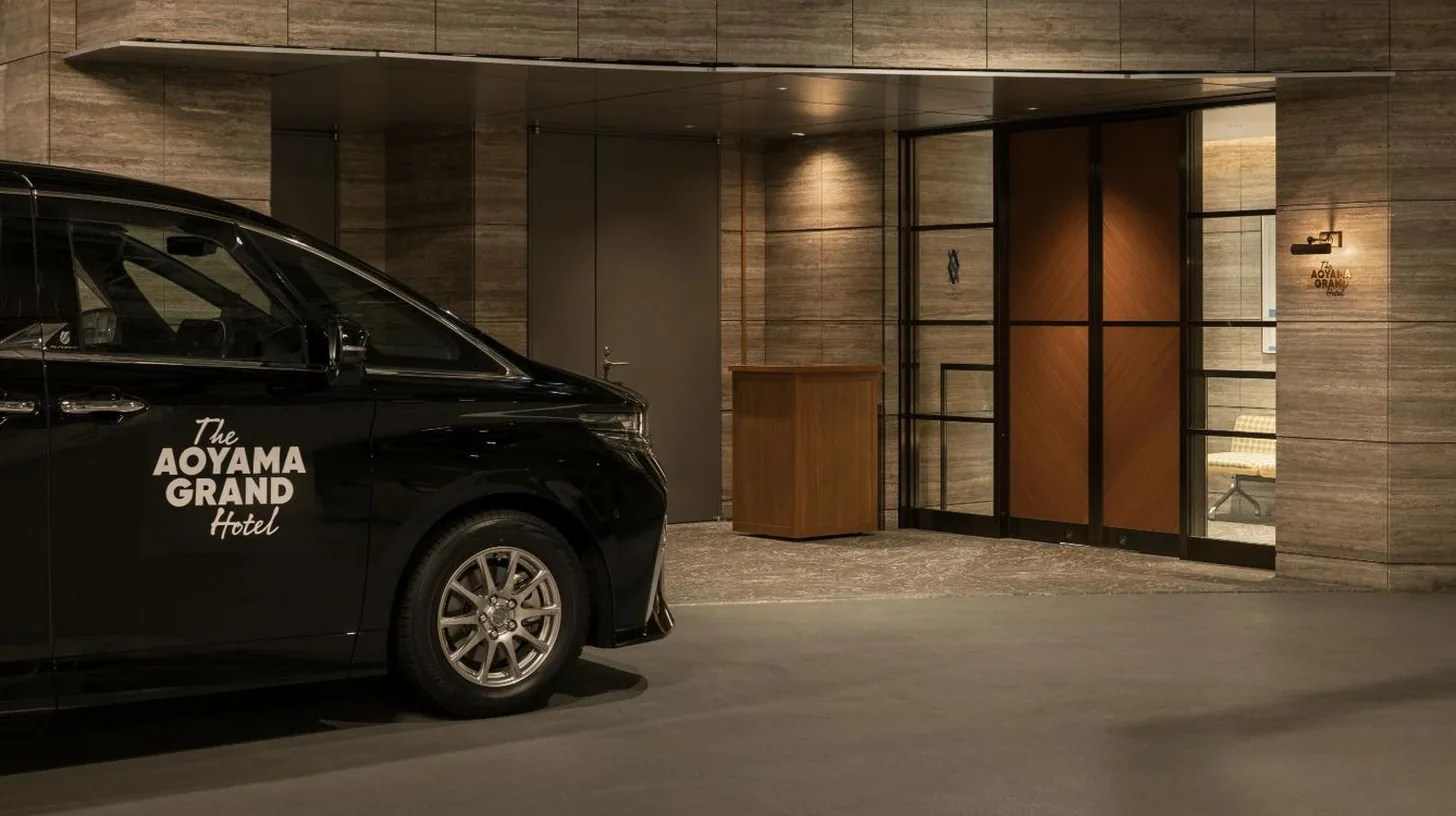a black car parked in front of a building at THE AOYAMA GRAND HOTEL in Tokyo