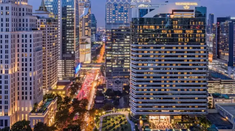 a city skyline at night with tall buildings at The Athenee Hotel