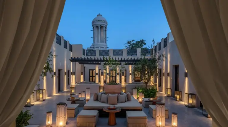 a view of the courtyard of a building with a clock tower at The Chedi Al Bait