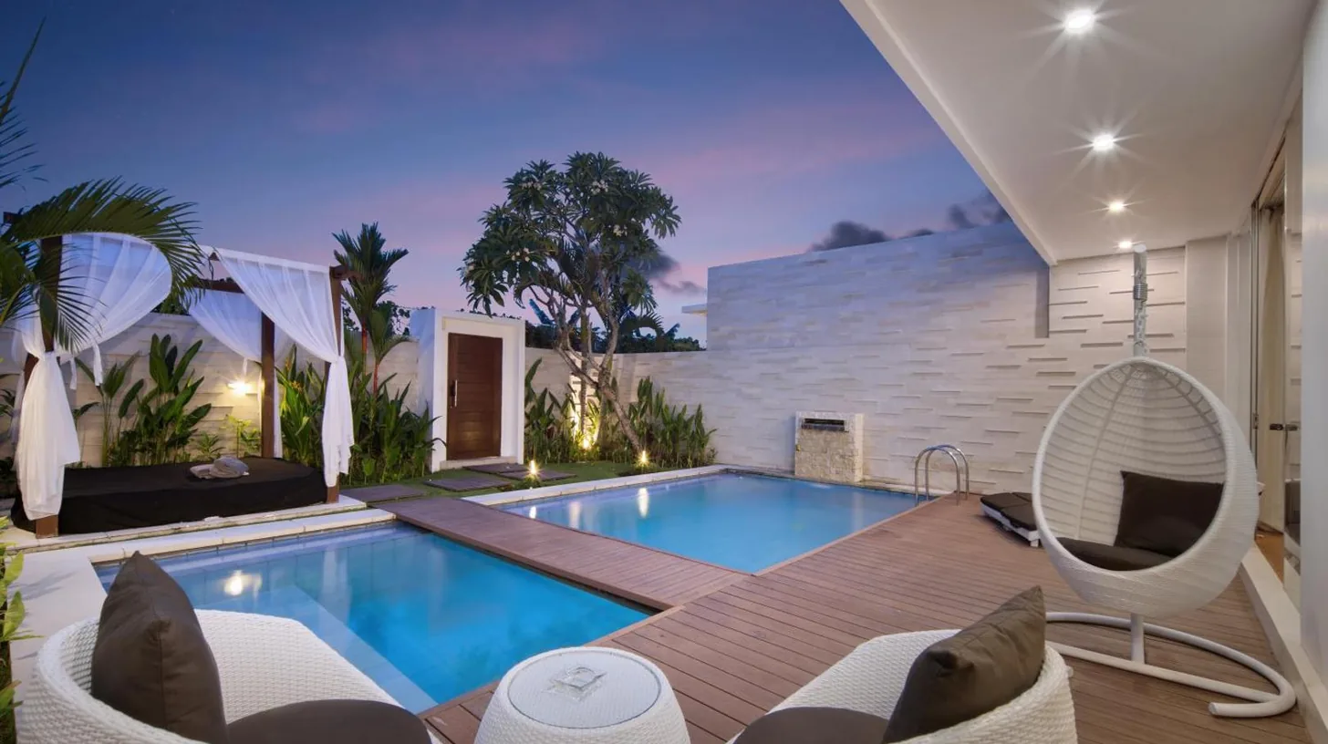a bathroom with a tub and a toilet and a sink at The Daha Luxury Villas in Seminyak