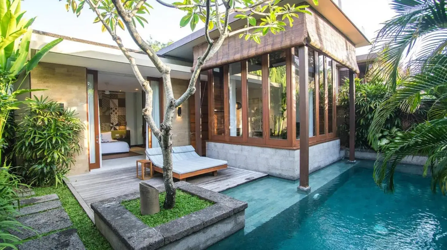 ein Wohnzimmer mit einer Couch und blauen Kissen im The Elysian Boutique Villa Hotel in Seminyak