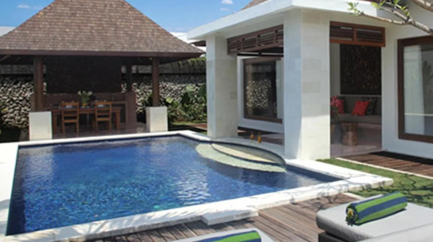 a swimming pool in the backyard of a villa at The Haere Seminyak - By Astadala in Seminyak