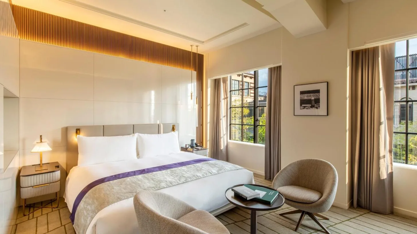 a hotel room with a bed and two chairs at The Hotel Seiryu Kyoto Kiyomizu - a member of the Leading Hotels of the World- in Kyoto