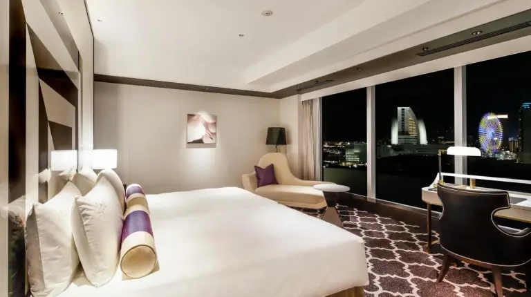 a hotel room with a large bed and a desk at The Kahala Hotel & Resort Yokohama in Yokohama