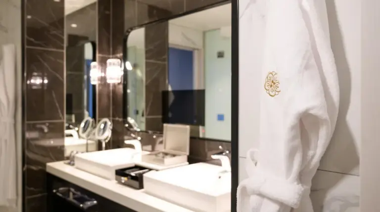 a bathroom with a sink and a mirror at The Kahala Hotel & Resort Yokohama in Yokohama