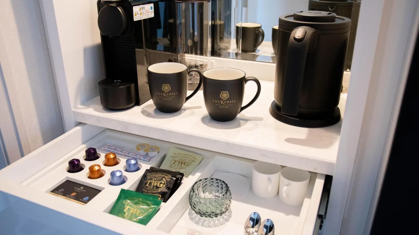 a shelf with coffee cups and other items on it at The Kahala Hotel & Resort Yokohama in Yokohama