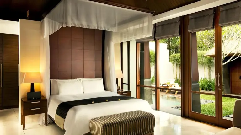 a bedroom with a large bed with a canopy at The Kayana in Seminyak