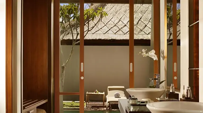 a bathroom with two sinks and a large mirror at The Kayana in Seminyak