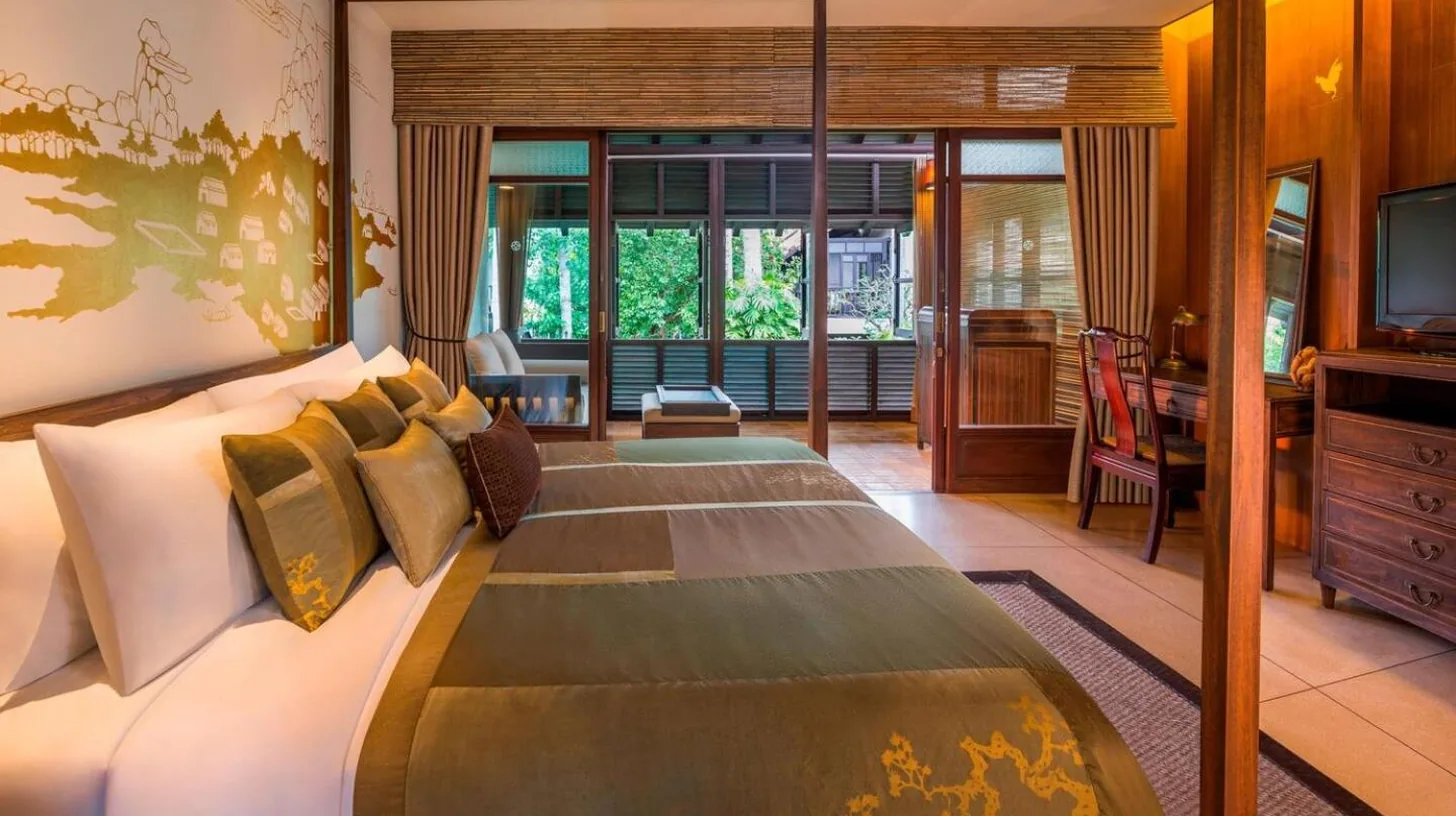 a bedroom with a large bed and a television at The Lamai Samui in Lamai