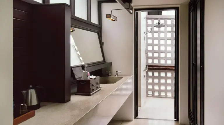 a bathroom with a toilet and a mirror at The Lamai Samui in Lamai