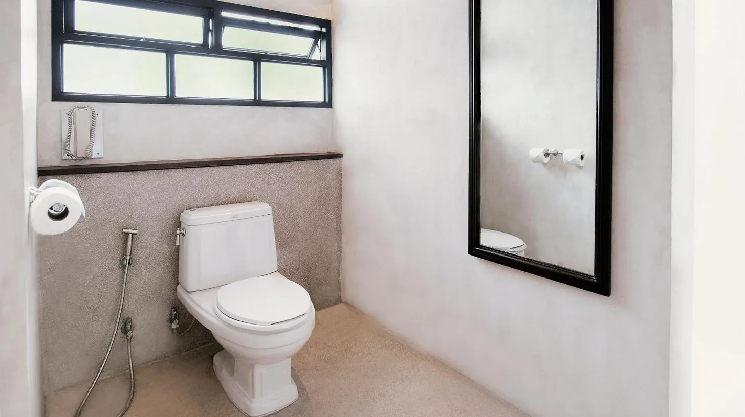 a bedroom with a bed and a desk and a table at The Lamai Samui in Lamai