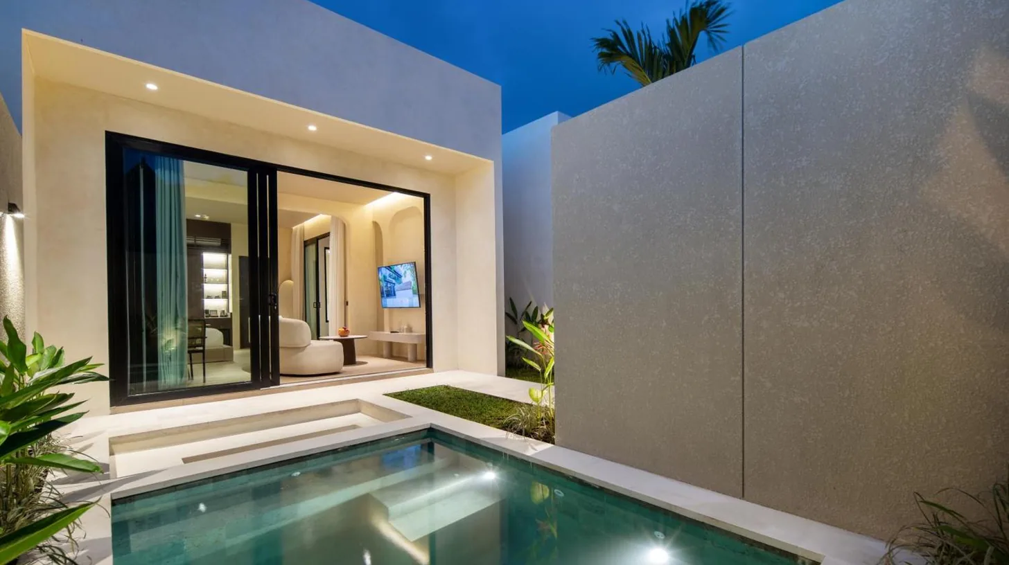 a living room with a white couch and a table at The Lario Collection - A Wellness Resort in Seminyak