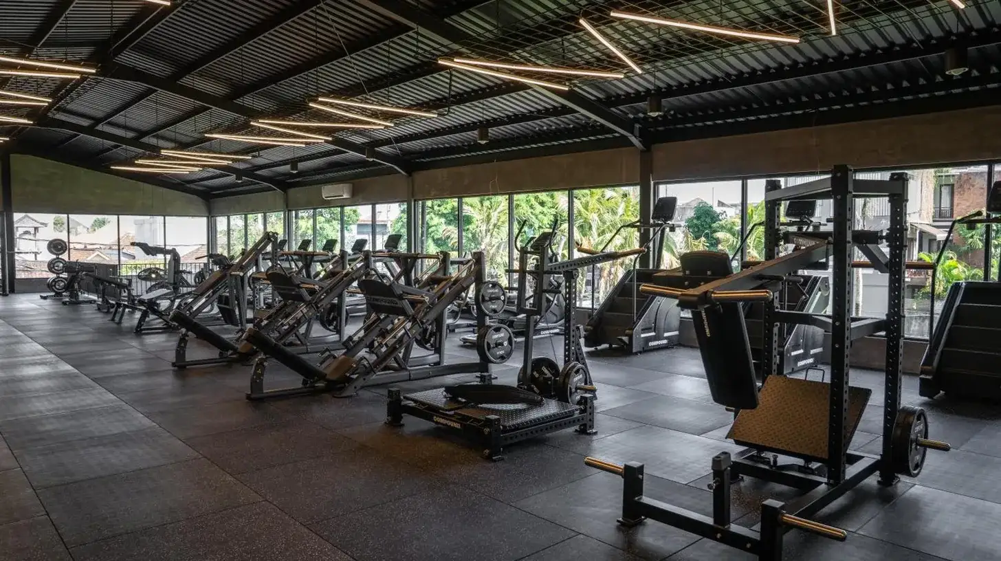 a gym with several rows of weight machines at The Lario Collection - A Wellness Resort in Seminyak