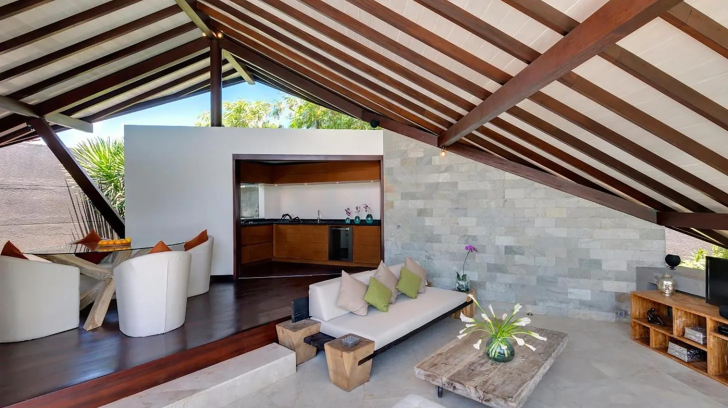 a bathroom with a toilet and a glass shower at The Layar - Designer Villas and Spa in Seminyak
