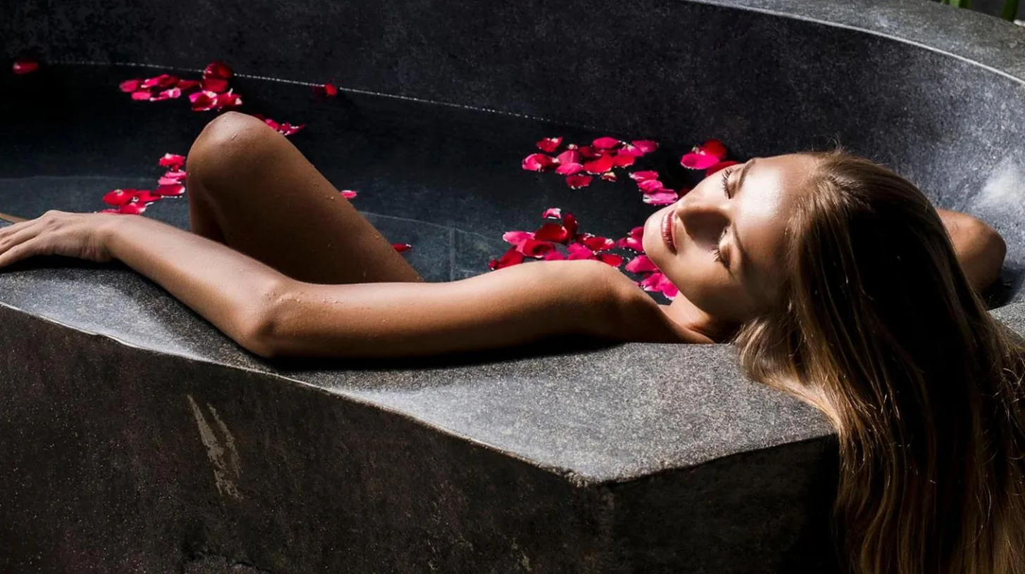 two people sitting in a hammock next to a pool at The Layar - Designer Villas and Spa in Seminyak