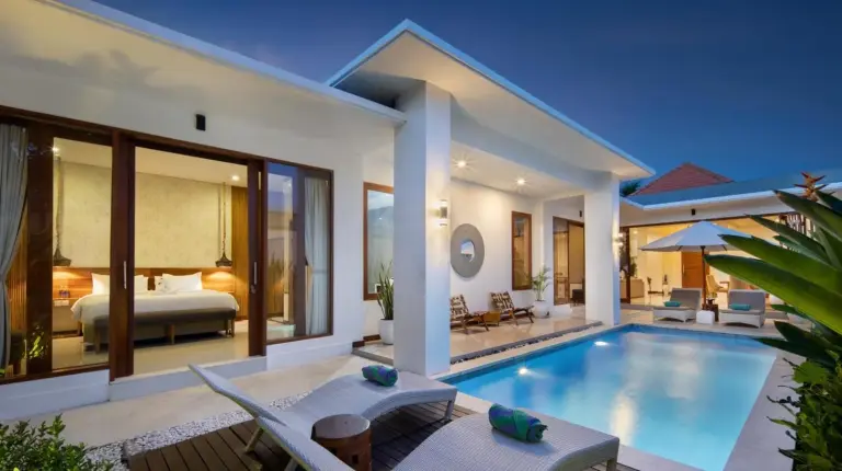 a villa with a swimming pool and a bedroom at The Luxury Collection