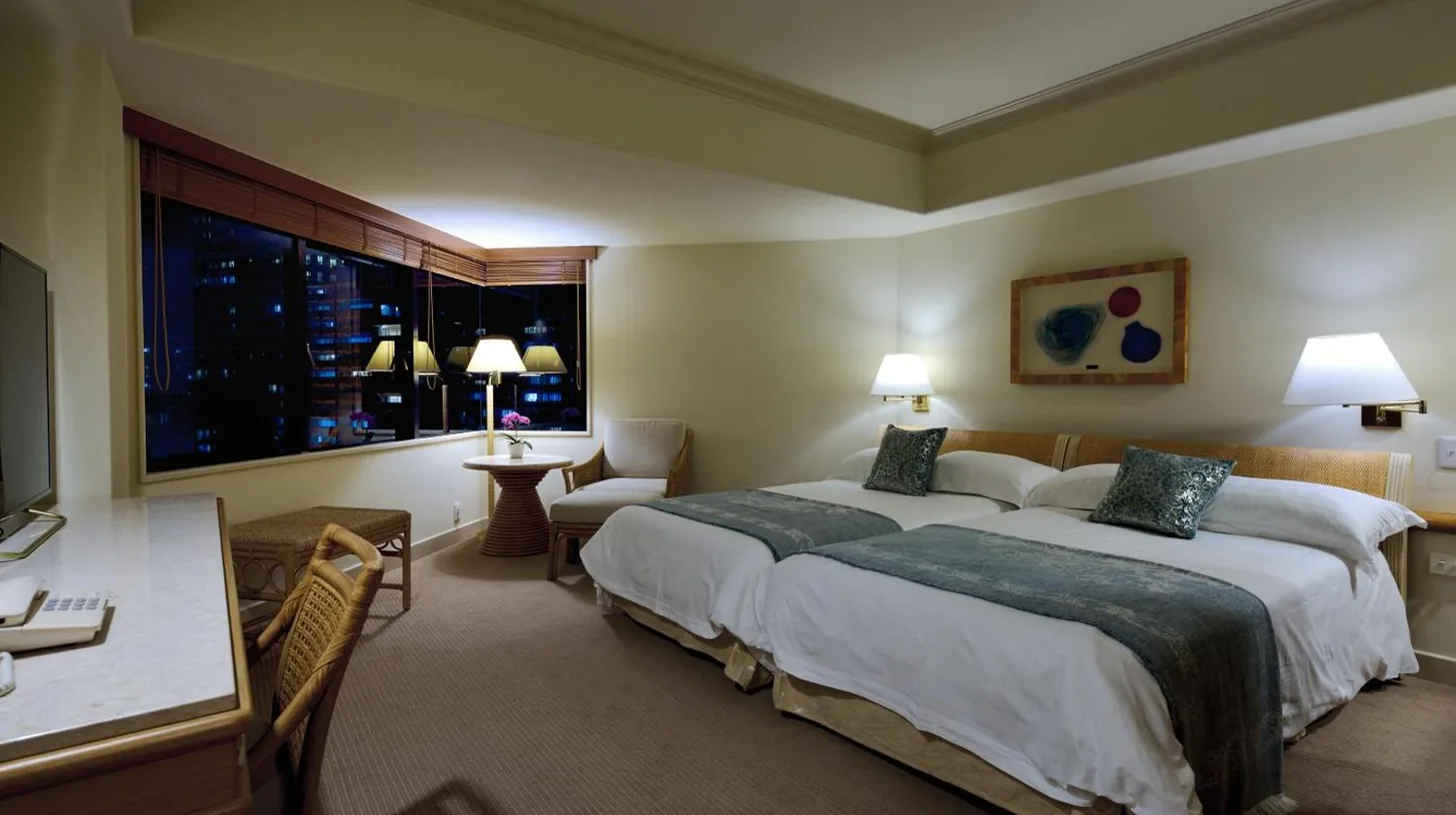 a hotel room with a large bed and a window at The Naha Terrace in Naha