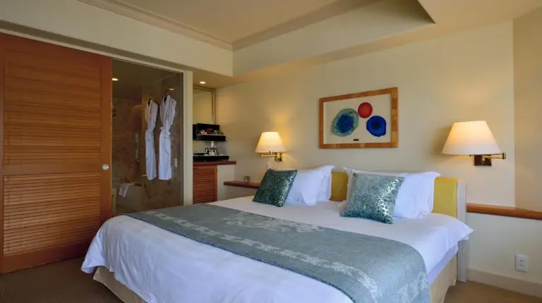 a hotel room with two beds and a couch at The Naha Terrace in Naha