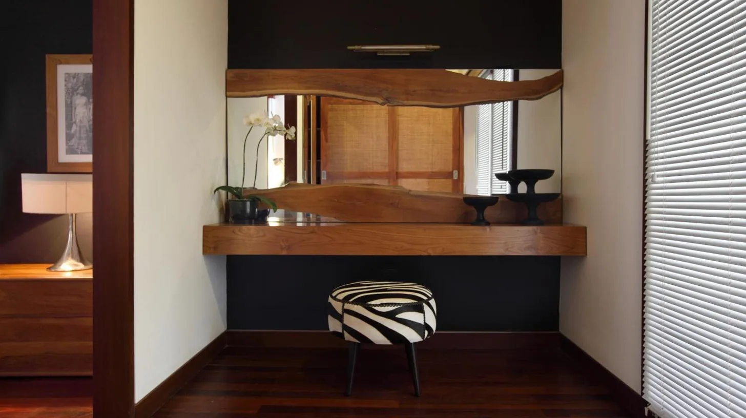 a room with a mirror and a chair in a room at The One Boutique Villa & Spa Seminyak in Seminyak