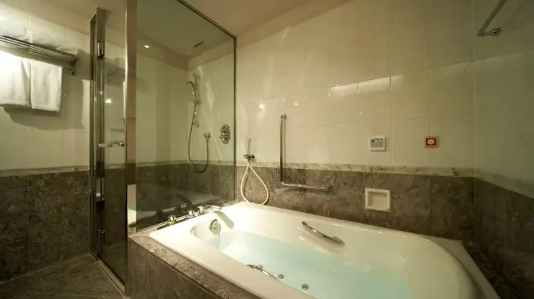 a bath tub with water pouring out of a faucet at The Prince Park Tower Tokyo - Preferred Hotels & Resorts